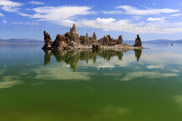 Tufa formation in the middle of a clear lake on a sunny day with blue sky, Mono Lake, North