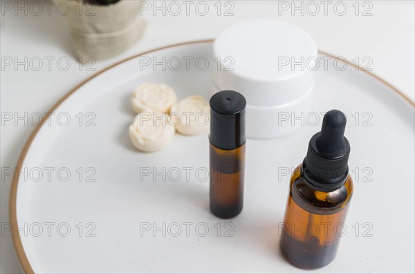 Cosmetic packaging. Set of different cosmetics on plate with decoration. Skin care concept