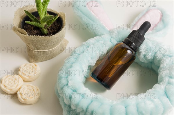 Cosmetic packaging. Set of different cosmetics on plate with decoration and bunny headband