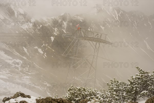 Cable car technicians working in bad weather conditions, Nebelhorn cable car near Oberstdorf,