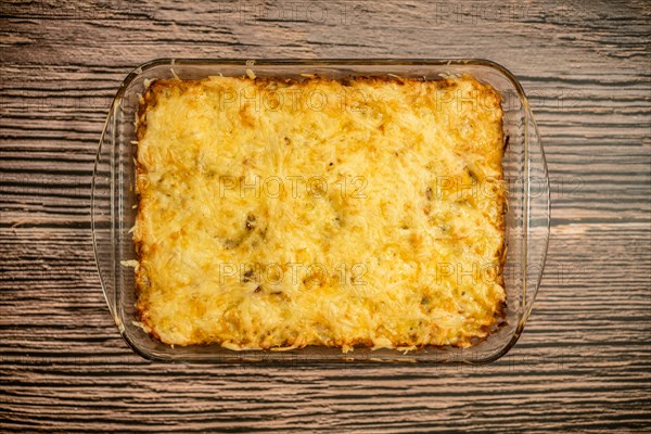 Top view of pie with meat and potato baked in oven in glass baking tray