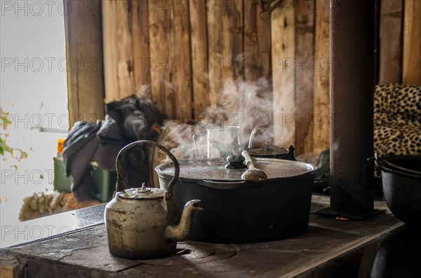 Beautiful steel kettle on wood stove in the countryside, Cambara do sul, Rio Grande do sul, Brazil,