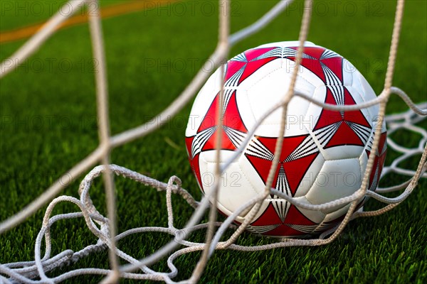 Close up of soccer ball inside the net field. Soccer ball inside the goal field. Football fever