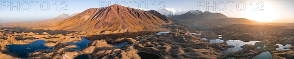 Aerial view, high mountain landscape with glacial moraines and mountain lakes, behind Pik Lenin,