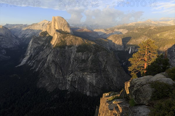 Warm evening light illuminates Half Dome and the surrounding cliffs of Yosemite, Yosemite National