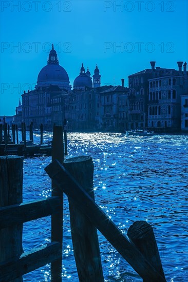 Silhouetted view of Grand canal with water taxis, Santa Maria della Salute basilica and Renaissance