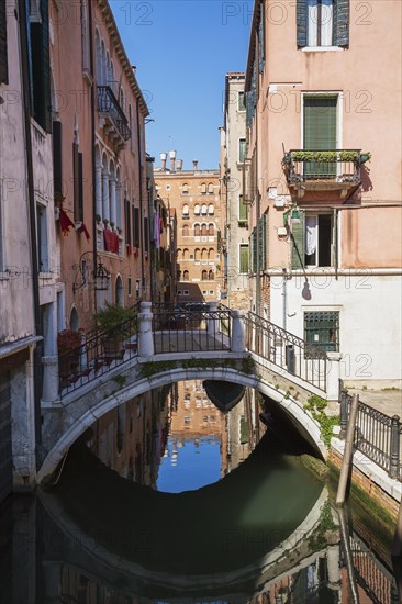 San Angelo Canal with footbridge and old pinkish and white architectural style residential