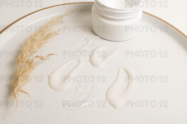 Cosmetic smears of creamy texture on a beige background
