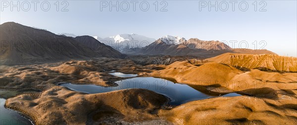 Aerial view, high mountain landscape with glacial moraines and mountain lakes, behind Pik Lenin,