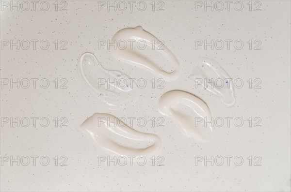 Cosmetic smears of creamy texture on a beige background