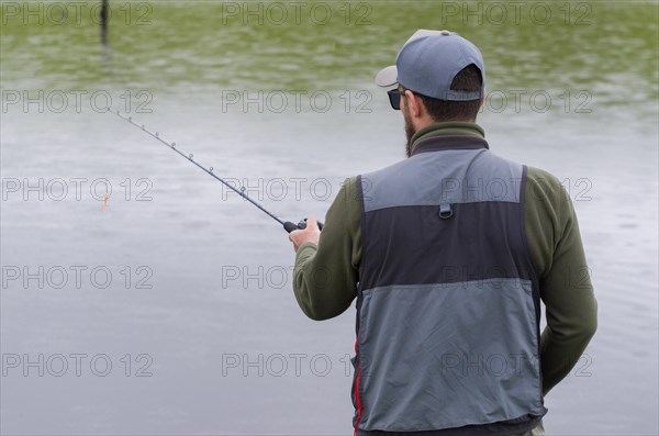Black bass fisherman fishing inside lake, Cambara do sul, Rio Grande do sul, Brazil, South America