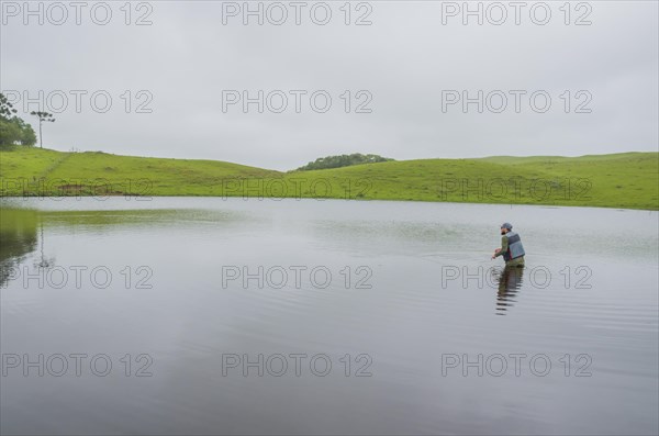 Black bass fisherman fishing with flyfishing, Cambara do sul, Rio Grande do sul, Brazil, South