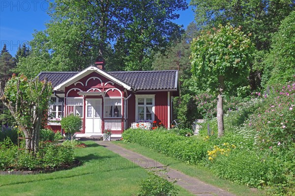 Small red wooden house in a garden, lock keeper's house, waterway, Dalsland Canal, Dalsland,