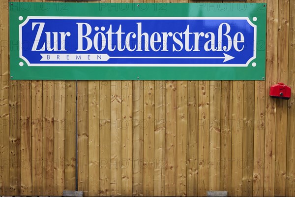 Signpost to Boettcherstrasse on a wooden fence in Bremen, Hanseatic City, State of Bremen, Germany,