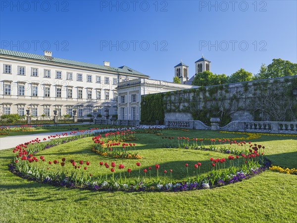 Mirabelle plum palace with flowers in the foreground, Mirabelle gardens, blue sky, Salzburg,