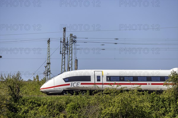 Deutsche Bahn AG InterCityExpress ICE en route, railway embankment and overhead lines,