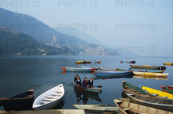 Schoolgirls going to school, juvenile, boating, lake Phewa, Pokhara, Nepal, Asia