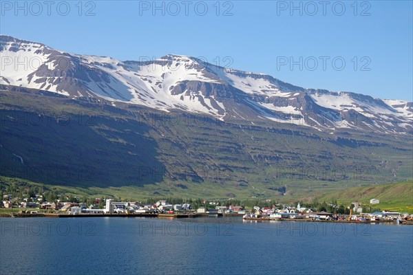Small village under snow-covered, rugged mountains, ferry town, Seydisfjoerdur, East Iceland,