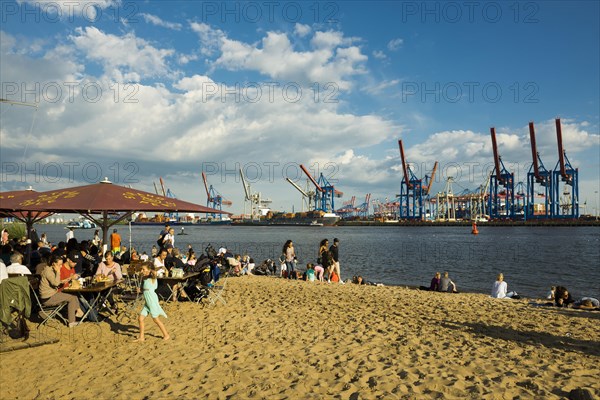 People on the beach, Strandbar Strandperle, Elbe beach, Hamburg harbour in the background,