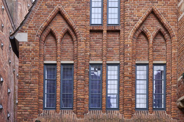 Windows and arched decorations on a brick house in Boettcherstrasse in Bremen, Hanseatic city,