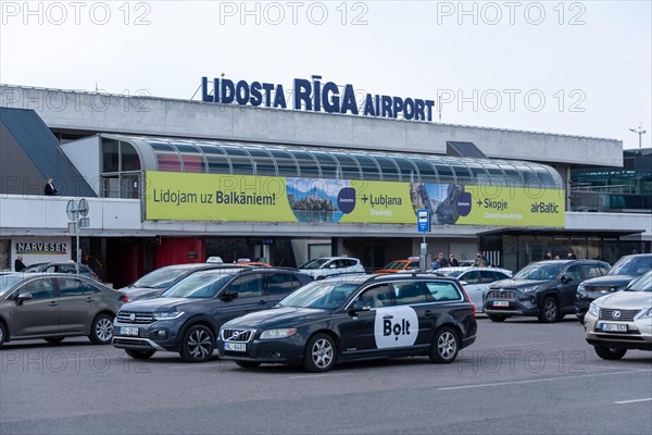 View of the airport building of the Latvian capital Riga, taxis of the company Bolt, Riga, Latvia,