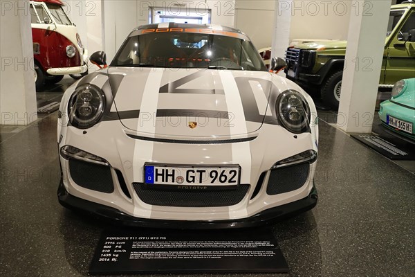 White Porsche 911 GT3 RS A Porsche 911 GT3 RS as a racing car concept at a car exhibition,