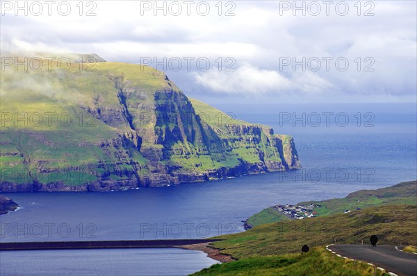 View over high mountains, cliffs and a mountain road, Eidi, Tjornuvik, Faroe Islands, Denmark,