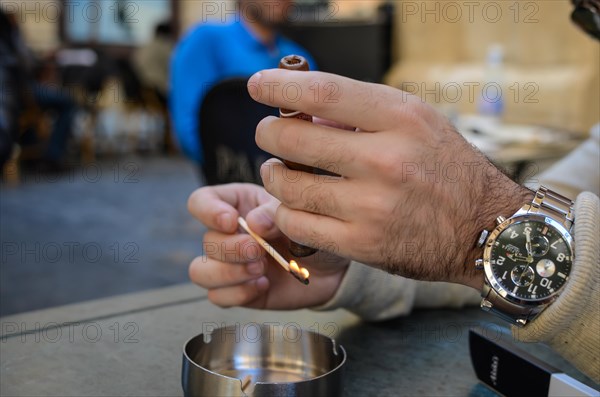Beirut, Lebanon, April 04, 2017: lighting cigar in street bar in downton beirut, Asia
