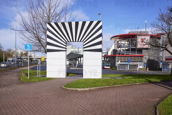 La Porta Aperta, sculpture by artist Marcello Morandini with bus station and Kaufland multi-storey