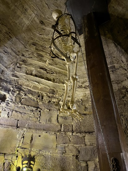Depiction with artificial skeleton of historical torture at the bottom left of the picture,