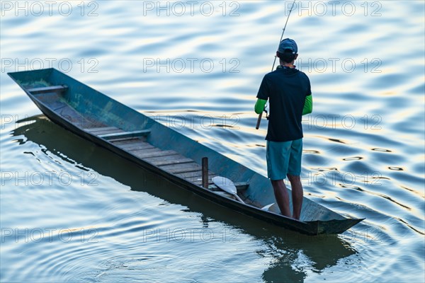 Fisherman with boat on the Mekong, Luang Prabang, Laos, Asia