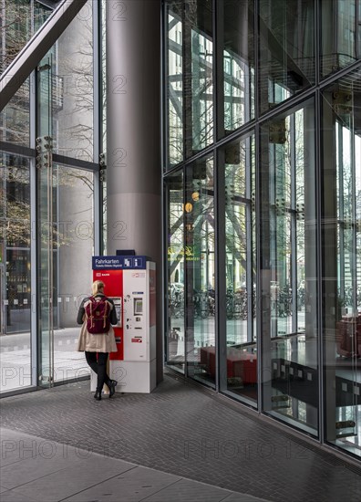 Woman standing at a Deutsche Bahn ticket machine, Berlin, Germany, Europe