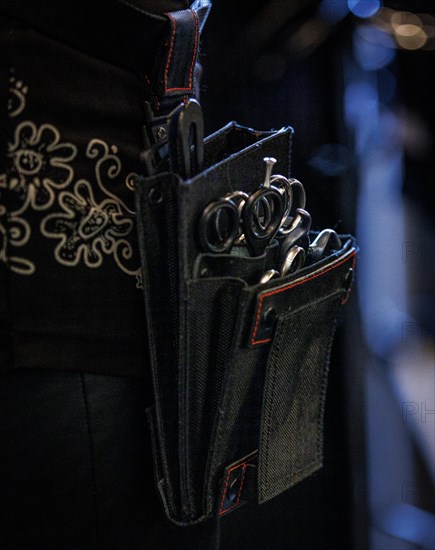 Hair scissors in a hairdresser's belt bag, taken in the hairdressing salon Coiffeur Sivan in