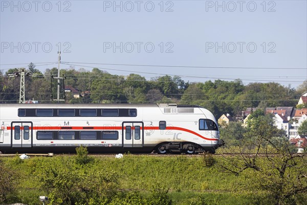 Deutsche Bahn AG InterCity en route, railway embankment and overhead lines, infrastructure,
