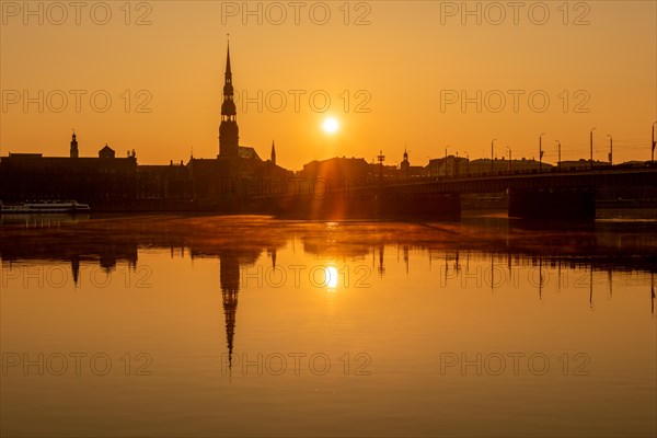 Sunrise on the Daugava River behind St Peter's Church, Riga, Latvia, Europe