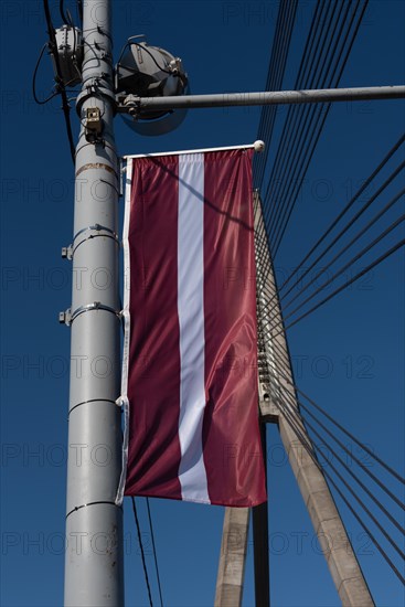 National flag of Latvia, hanging on the Vansu Bridge, Riga, Latvia, Europe
