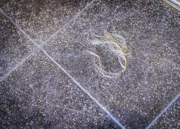 Hair on the floor of a hairdressing salon, taken in the hairdressing salon Coiffeur Sivan in