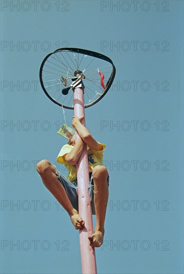 Boy climbs on maypole, barefoot, Heiligenthal, Lower Saxony, Germany, 20/06/1992, vintage, retro,