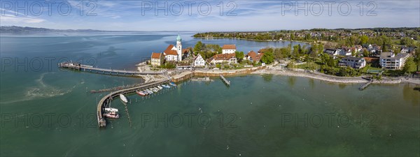 Moated castle peninsula with castle and parish church of St George on Lake Constance. Aerial photo,