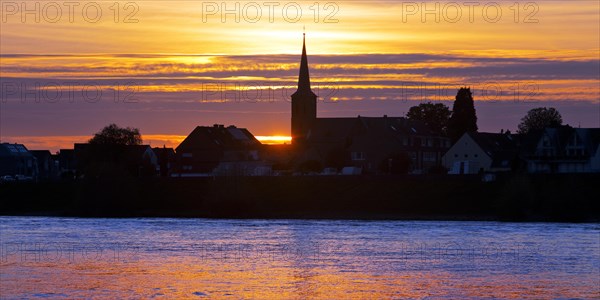 Rhine at sunset with the church of St Dionysius in Volmerswerth, Duesseldorf, Lower Rhine, North