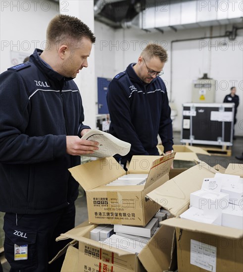 Customs officers check a load of an aircraft that has landed in the cargo area at the airport,