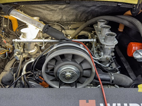 View into engine compartment of vintage historic Porsche 911, front centre fan wheel, right three