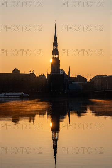 Sunrise on the Daugava River behind St Peter's Church, Riga, Latvia, Europe