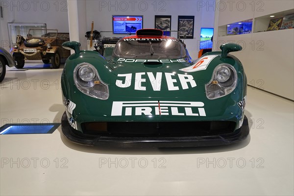 PORSCHE 911 GTI 98, A green Porsche racing car with Jever and Pirelli advertising in a museum,