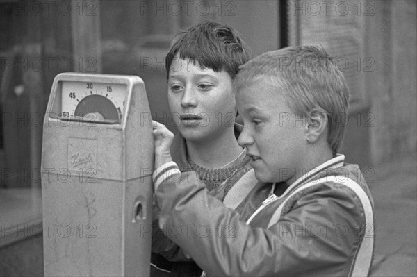 Two boys examining a parking meter, Bamberg, Upper Franconia, Bavaria, Germany, 26 October 1987,