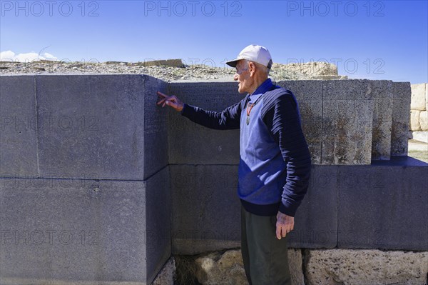 Ruins of the Urartian citadel of Cavustepe, Wardian explaining the cuneiform writing, Van, Turkey,