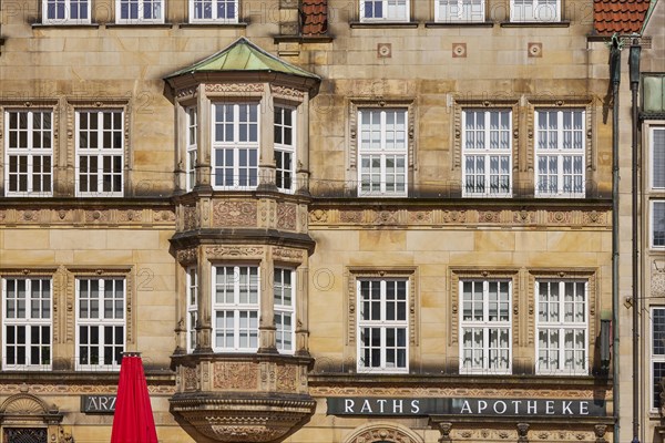Facade with white windows of the Raths Apotheke and the medical centre on the market square in