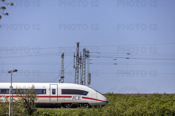 Deutsche Bahn AG InterCityExpress ICE en route, railway embankment and overhead lines,