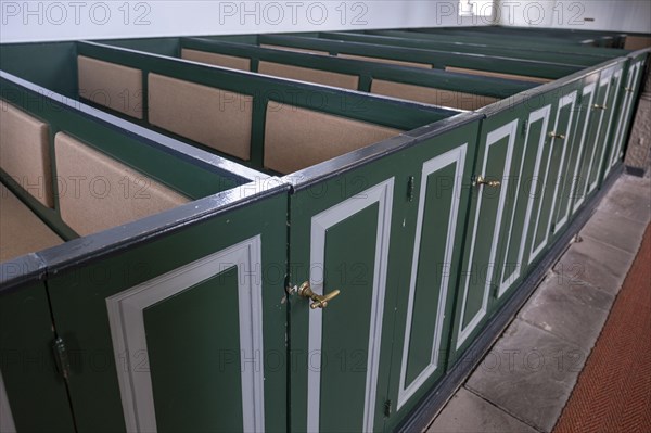 Pews with green doors in the Protestant Reformed Church from 1401 in Greetsiel, Krummhoern, East