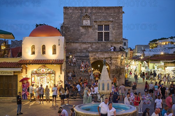 St Paul's Gate, Hippocrates Square, Lively square at night with a fountain and surrounding shops,